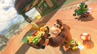 Donkey Kong zwinkert und hälte eine Banane in Mario Kart World hoch