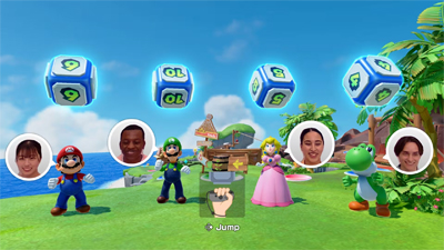 Vier Spieler in Mario Party Jamboree stehen unter den Würfeln und auf dem Bildschirm sind die Gesichter per Kamera eingeblendet