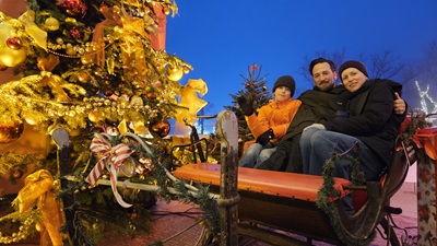 Frau, Mann und Kind in einem Schlitten