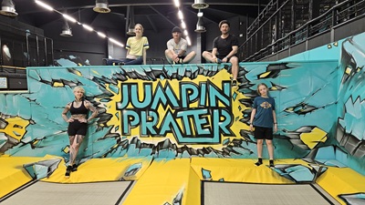 5 Personen haben sich um die Running Wall von Jumpin Prater platziert