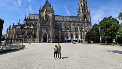 Mann und Frau stehen auf dem großen freien Platz mit dem Mariendom im Hintergrund.