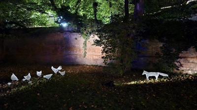 Ein Fuchs blickt auf eine Gruppe Hühner. Installationen von Katja Paternoster bei The Sound of Light in Wien